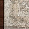Detailed view of rug corner highlighting texture and patterned border on hardwood floor