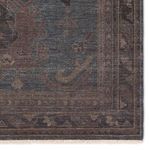 Close-up of corner edge highlighting the intricate border pattern and short fringe ends