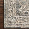 Detailed corner view of rug on dark wood floor highlighting pattern and fine weaving