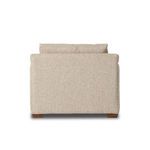 Back view showing taut fabric upholstery and wooden feet