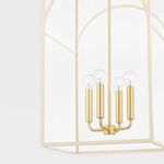 Close-up on four cylindrical light sockets with clear bulbs in pendant’s brushed nickel frame