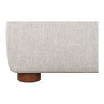 Detail close-up of rounded wooden leg supporting the upholstered neutral-toned Luzon bed frame