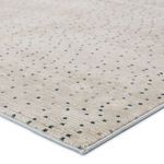 Close-up of rug corner showing soft pile texture and stitched edge detailing