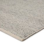 Close-up angle showing handwoven, braided texture and light gray and ivory yarn blend