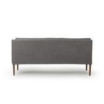 Straight back view showing clean back panel upholstery and amber oak legs