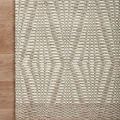 Kenzie rug corner on wood floor highlighting woven texture and edge finishing