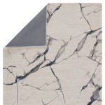 Corner flipped to reveal solid slate gray underside backing