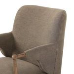 Close-up of Brently Dining Chair curved backrest and fabric texture with oak arm detail
