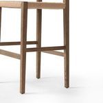 Close-up of Hamlin Stool's bottom oak frame leg joint and footrest detail