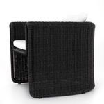 Woven chair showing full right side profile highlighting curved arm and wicker texture