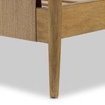 Close-up of tapered burnished parawood spindle leg supporting Richard Bed with smooth finish