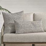 Pair of Stella Throw Pillows in square and rectangular shapes styled on gray outdoor sofa