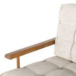 Close-up of armrest and tufted back cushion with visible fabric weave