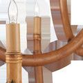Close-up of a candle bulb and tan sleeve set in thick rattan curved arm