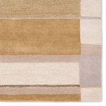 Close-up of rug corner showcasing distinct plush layers and color transitions between beige and gold