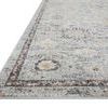 Low angled side view emphasizing rug’s thin profile and border design