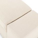 Overhead close-up of cushion and armrest junction showing uniform linen texture
