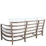 Back view of upholstered sofa with white cushions on oak frame featuring rounded edges and rattan wraps