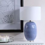 Westerly Blue Table Lamp styled on white console under black and white floral wall art with lit candles on reflective tray