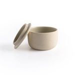 Detailed rim close-up showing soft cream matte glaze and gentle curve of jar lid