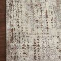 Close-up of rug corner lying flat on dark hardwood floor emphasizing pattern and color contrast