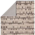 rug flipped corner revealing solid gray backing and striped top side