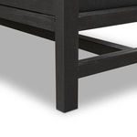 Close-up of the lower leg post and rails showing black wood grain and structural details