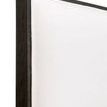 Detailed close-up focusing on upholstery seam and brown oak wood frame corner
