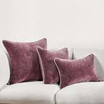 Three Harriet velvet throw pillows in varied sizes styled together on a white sofa