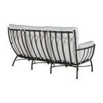 Angled back view emphasizing curved aluminum frame structure and three white cushion backrests