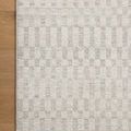 Corner section of Kamala rug placed on hardwood floor highlighting pattern and edge finish