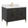 close-up showing white marble countertop with gray veining on black vanity base