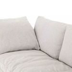 Two back pillows meeting at sofa corner with visible seam detail and padding softness
