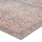Close-up of rug corner with detailed trellis motifs and tan edges captured at a low angle
