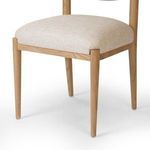 Detailed view of chair seat and front tapered legs from a lower angle