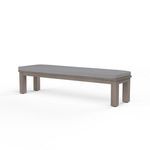 Laguna dining bench with hand-brushed aluminum frame in driftwood finish and gray cushioned seat