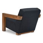 Three-quarter rear view showing angled backrest and blocky oak armrest of Garnet Lounge Chair