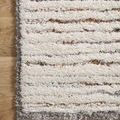 Corner close-up of Levitt Ivory shag rug showing pile detail and subtle multi-color threads