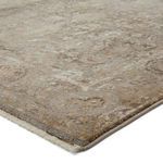 Close-up angled corner showing fringe and low pile texture with metallic accents