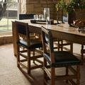 Close-up of dining chairs and table legs on textured Penny Gold / Natural Rug with natural light from window