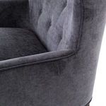 Close-up of armrest curve with visible stitching and velvet texture detail
