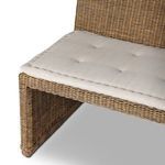 Side angle showing bench’s structural lines and contrast between woven frame and fabric