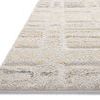 Side angle view showing rug’s textured raised pattern and low pile edge in neutral colors