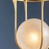 Verbank pendant shown from a slightly raised angle highlighting smooth gold cage curves