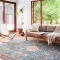 Layla Marine / Clay Rug in a bright living room with beige sofa and wooden framed windows