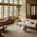 Similar view as second image showing large room context of rug with furniture and windows
