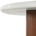 Low angle side view focusing on the curved marble top edge and the full height of the brown crescent leg
