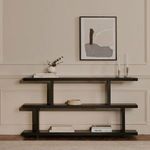 Miri Small Shelf styled with books and decor items against beige wall with abstract framed artwork above