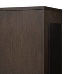Close-up showing the dark iron pull handles on rubbed black oak doors with wood grain