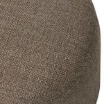 Close-up of curved ottoman top with visible woven textile texture in brown shades